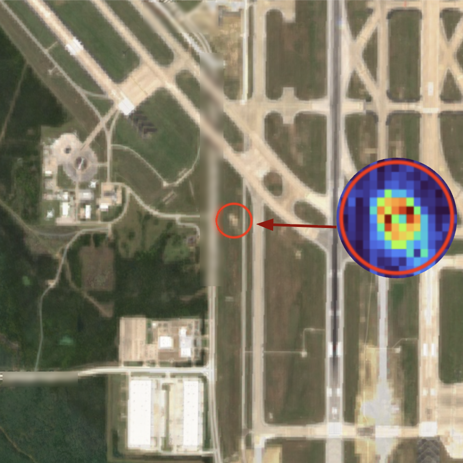 Satellite imagery with thermal detail highlighting construction activity near an airfield, street names blurred